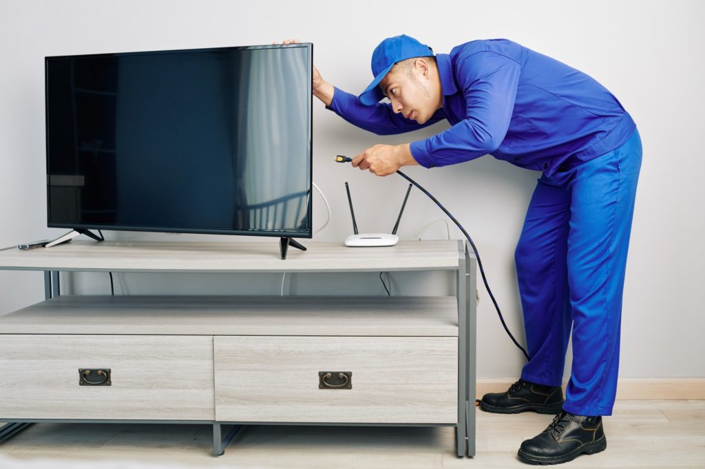Repairman installing tv set